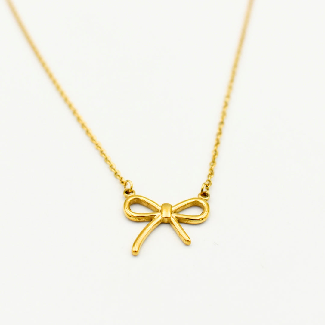 Gold Toned Pearl Bow Pendant Necklace