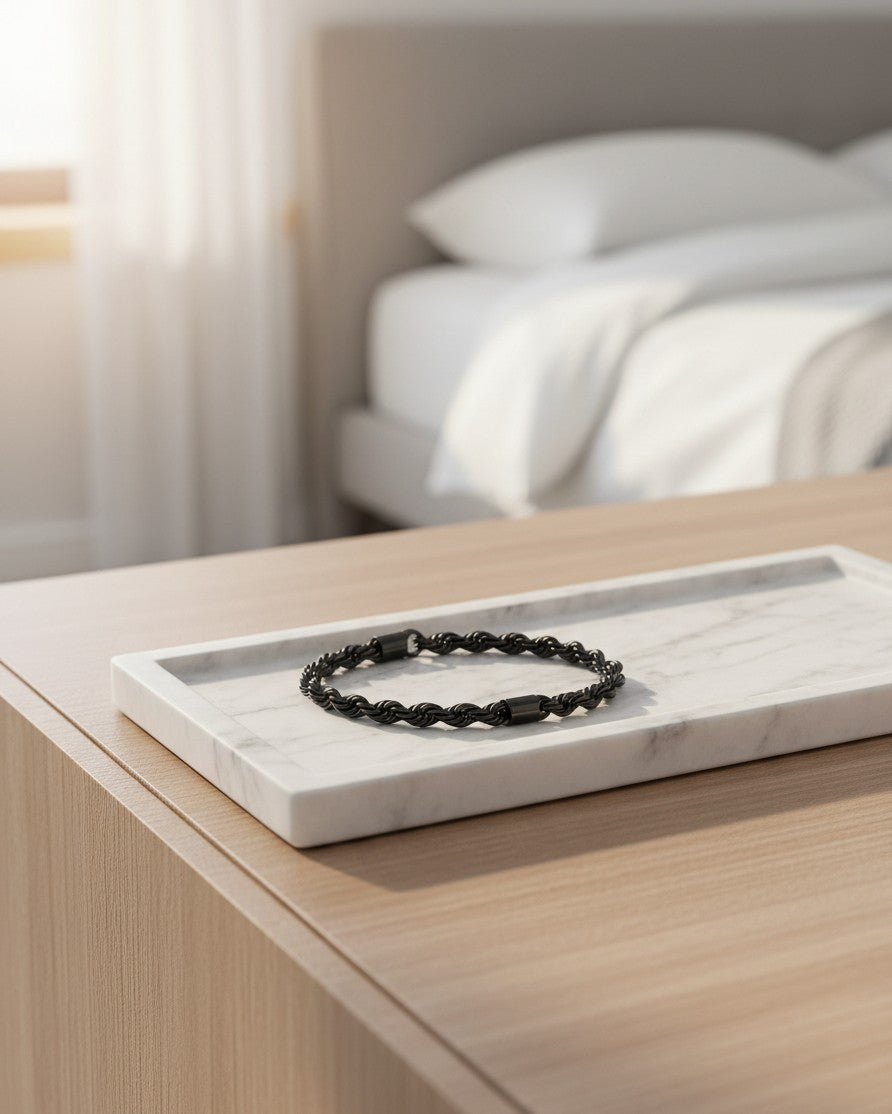 Elli Jewellery black rope chain bracelet resting on a white marble tray in a bedroom setting