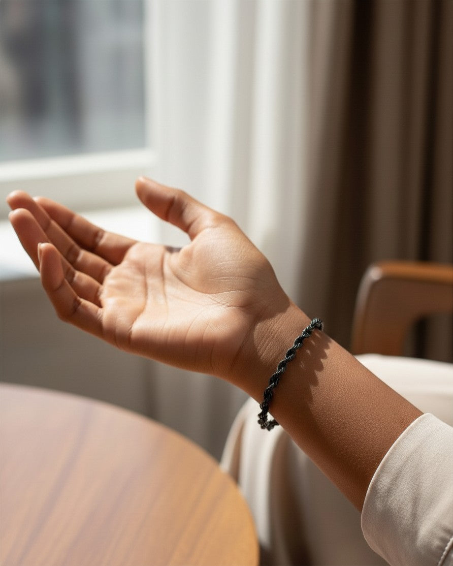 Elli Jewellery black rope chain bracelet worn on a model's wrist, featuring a sleek, waterproof, tarnish-free design.