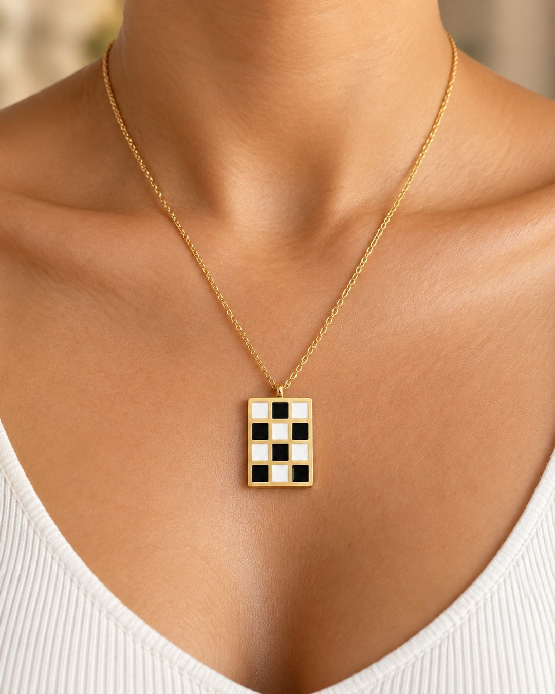 Elli Jewellery gold plated rectangular pendant necklace featuring a black and white checkered pattern on a fine chain