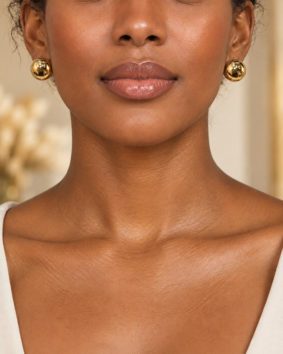 Elli Jewellery chunky dome stud earrings in polished 18ct gold plated metal worn by a model