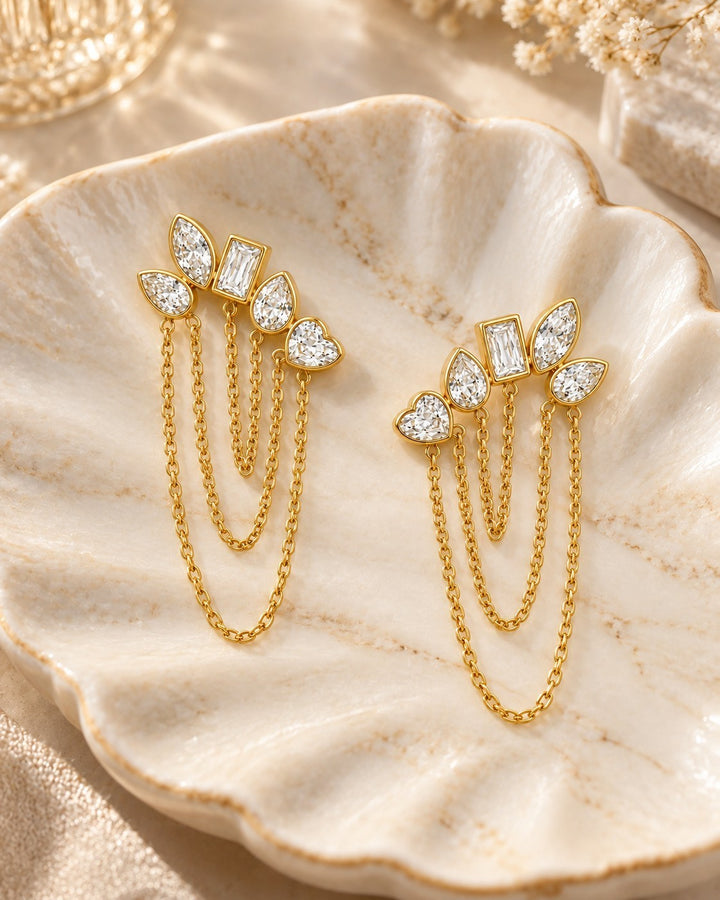 Elli Jewellery gold plated drop earrings featuring a cluster of mixed-cut crystals and delicate hanging chains.