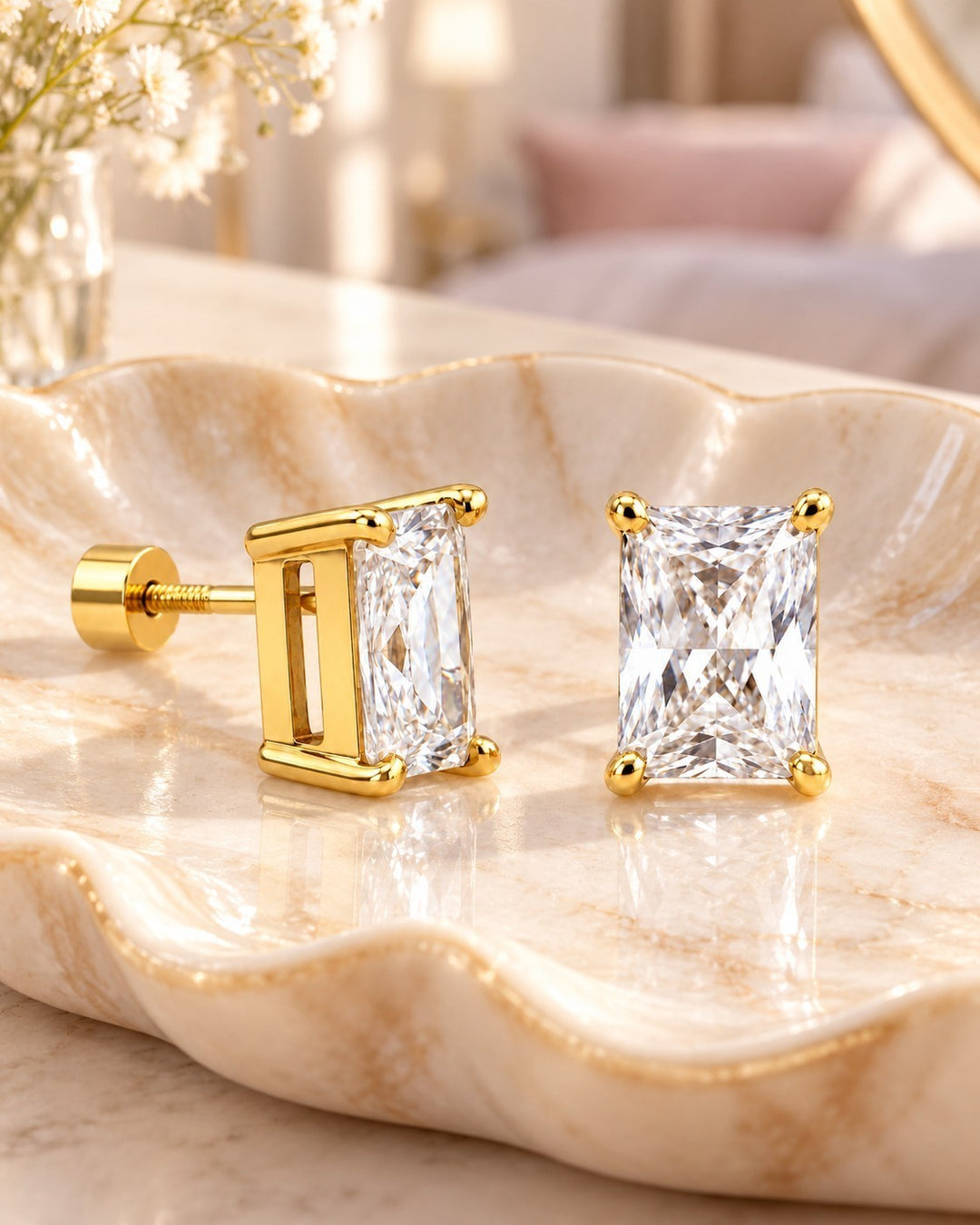 Elli Jewellery emerald cut cubic zirconia stud earrings in gold plated setting on a decorative marble tray