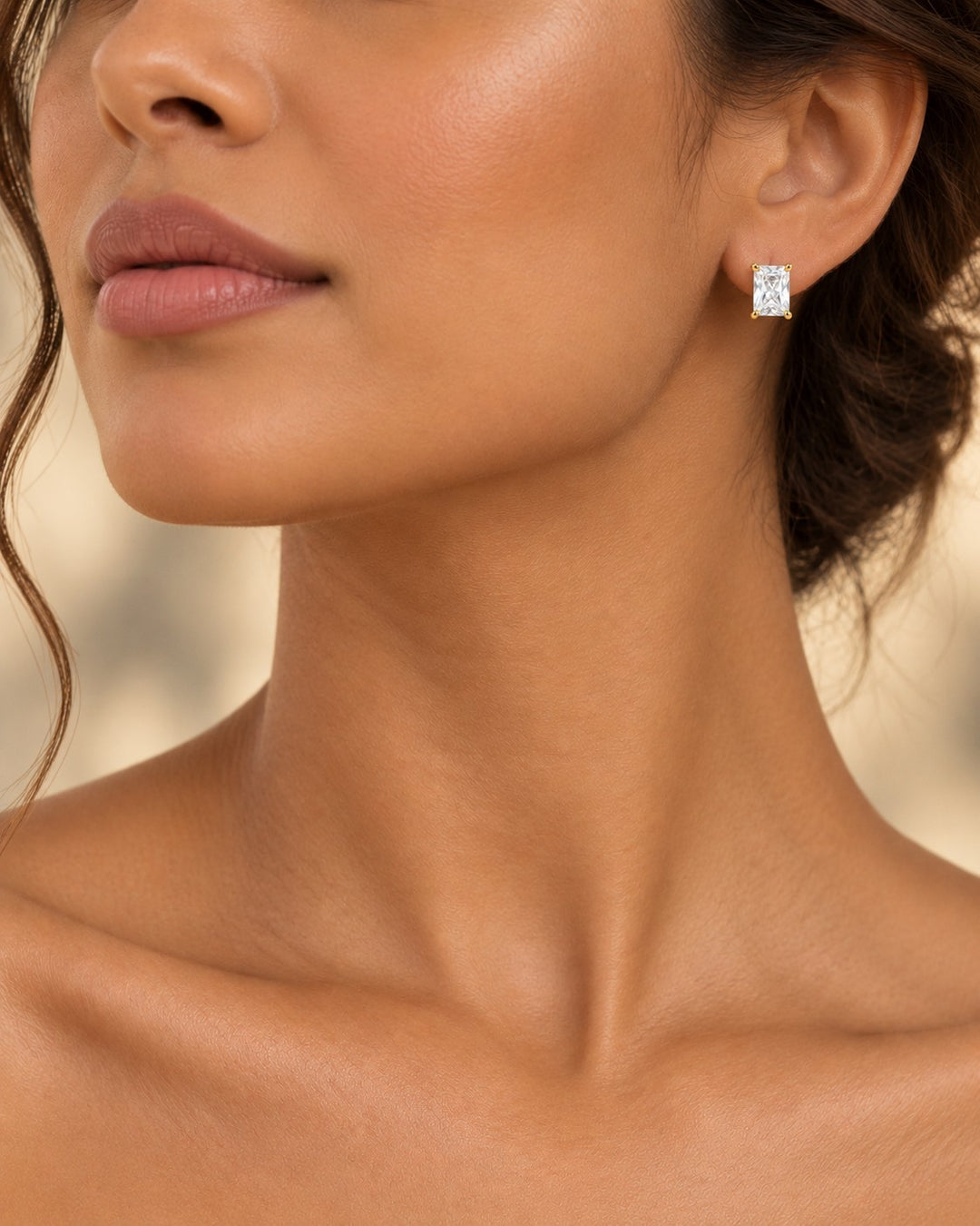 Elli Jewellery emerald cut cubic zirconia stud earring in gold plated setting worn on a model
