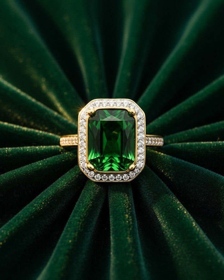 Elli Jewellery gold plated chunky ring featuring a large emerald green rectangular stone surrounded by sparkling crystals.