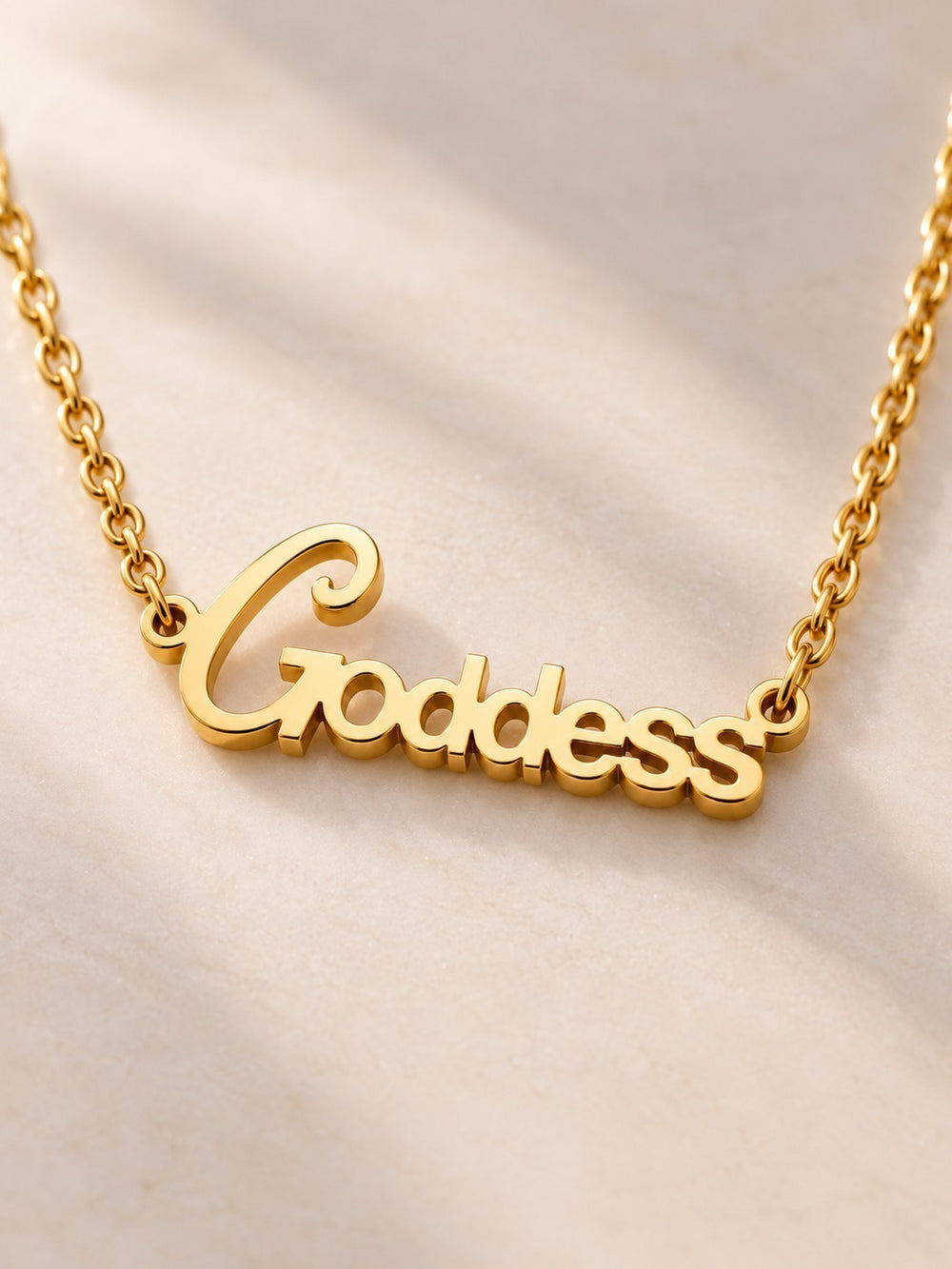 Elli Jewellery gold plated goddess pendant necklace with cursive lettering on a delicate chain