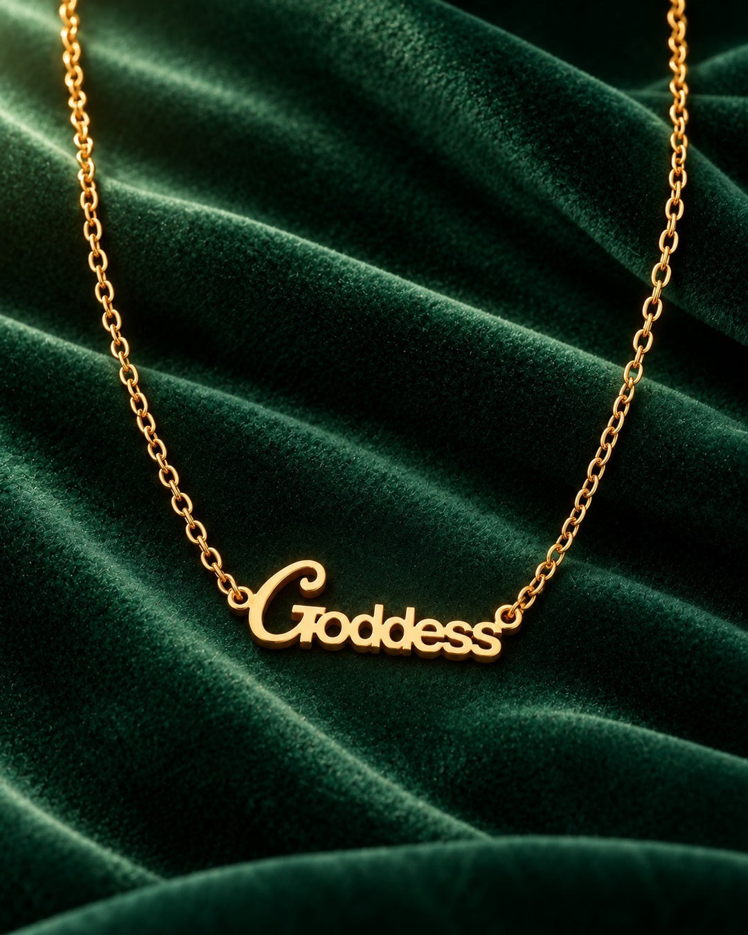 Elli Jewellery gold plated Goddess pendant necklace on a dark green velvet background