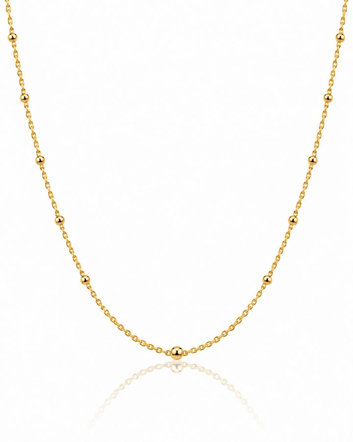 Elli Jewellery gold plated dainty ball bead chain necklace with a delicate minimalist design on a white background.