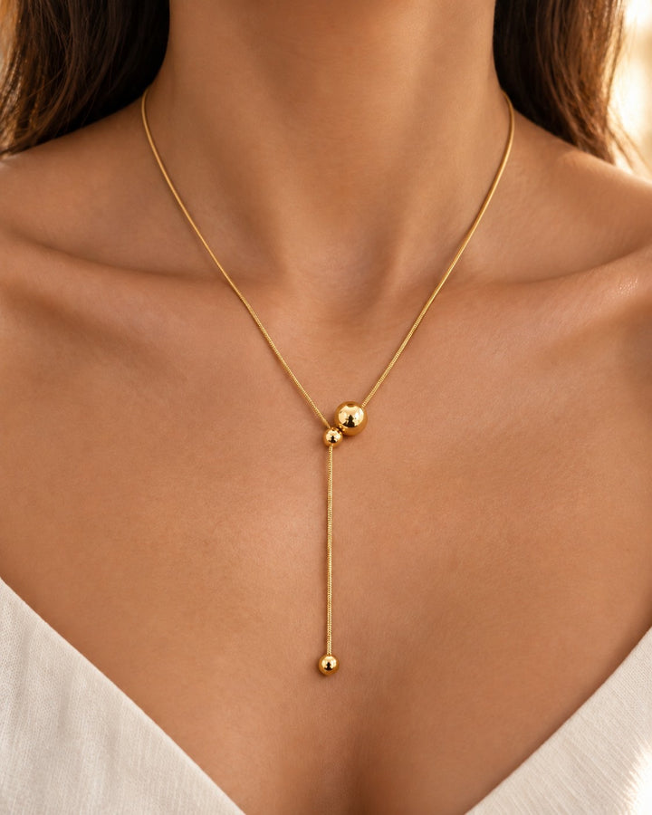Elli Jewellery gold plated minimalist lariat necklace featuring a delicate chain and two polished hanging ball charms.