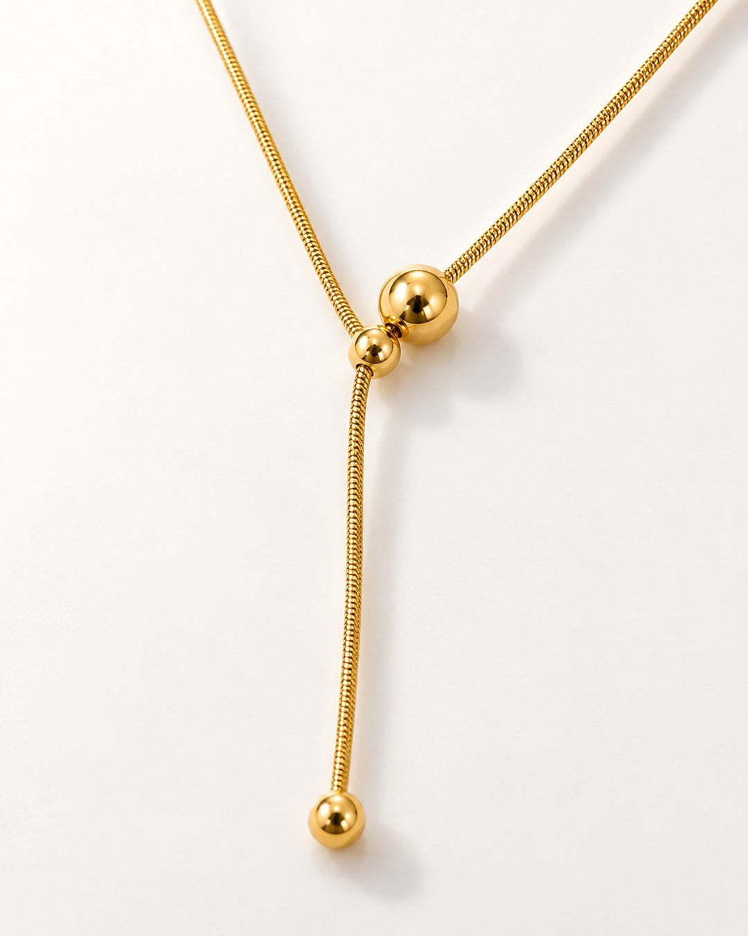 Elli Jewellery gold plated minimalist necklace featuring a delicate snake chain with two polished hanging ball charms.
