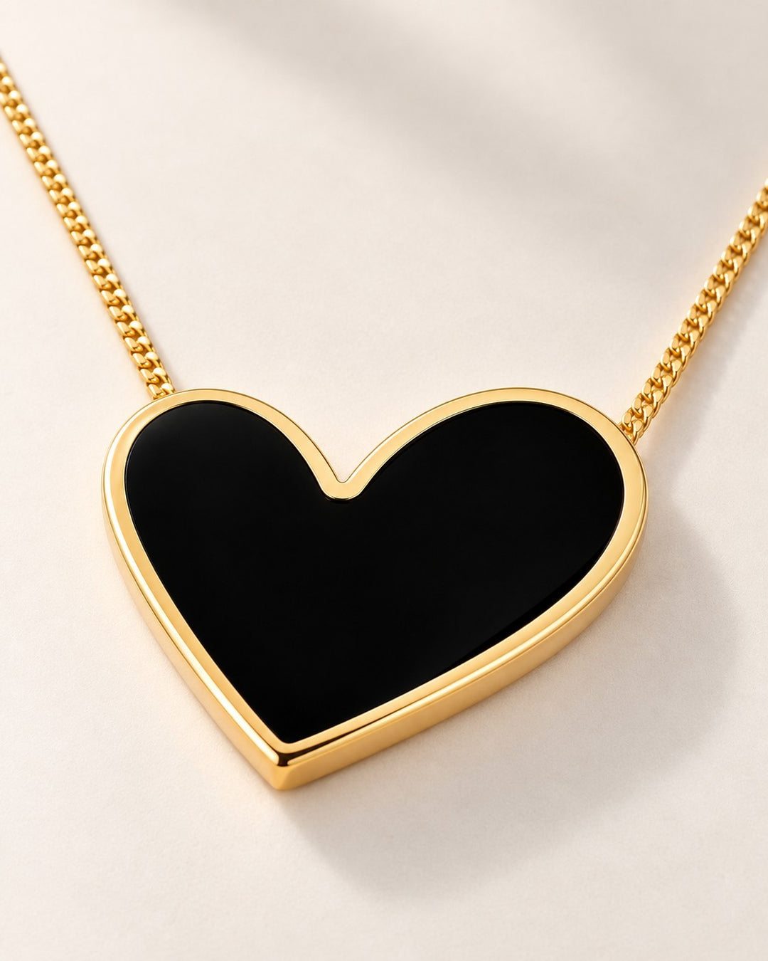 Elli Jewellery gold plated necklace featuring a glossy black enamel heart pendant on a delicate gold chain