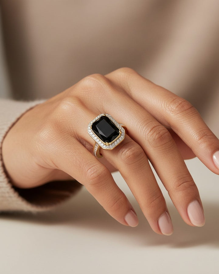 Elli Jewellery gold plated chunky ring featuring a large rectangular black stone surrounded by a halo of crystals.