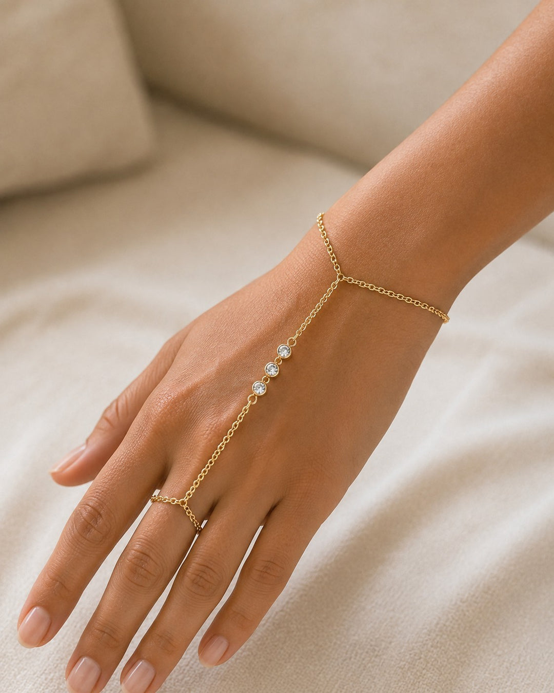 Elli Jewellery gold plated boho hand chain bracelet with delicate chain, ring, and sparkling crystal accents.