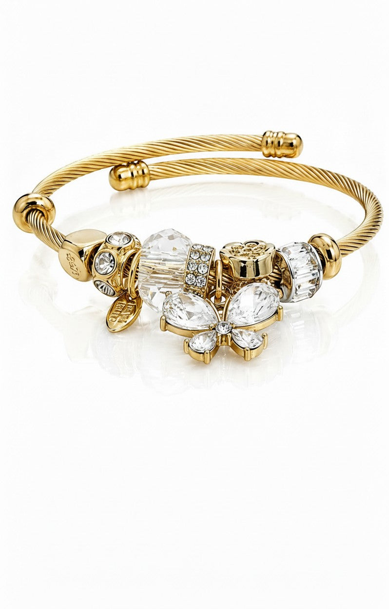 Elli Jewellery gold plated bangle featuring a crystal butterfly charm and sparkling pavé beads on a twisted band