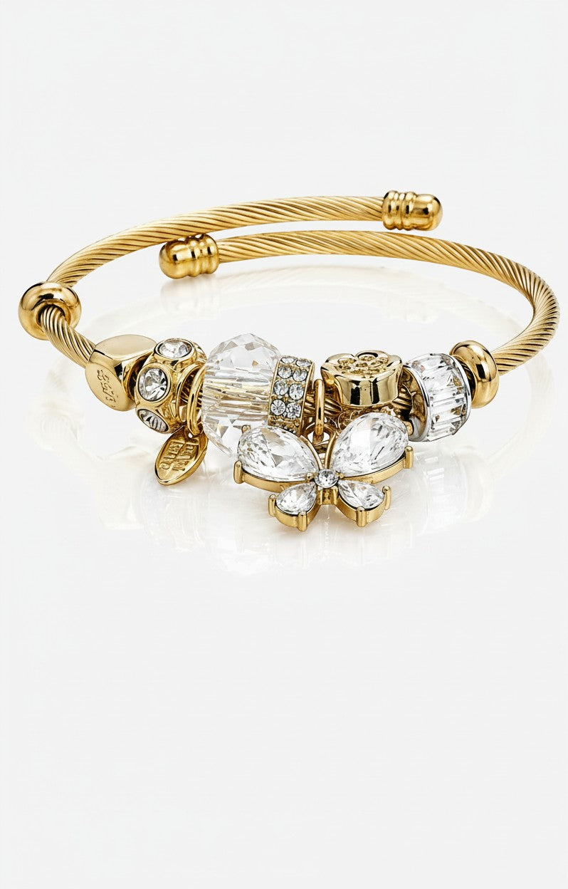 Elli Jewellery gold plated bangle featuring a crystal butterfly charm and sparkling diamanté beads on a twisted band.