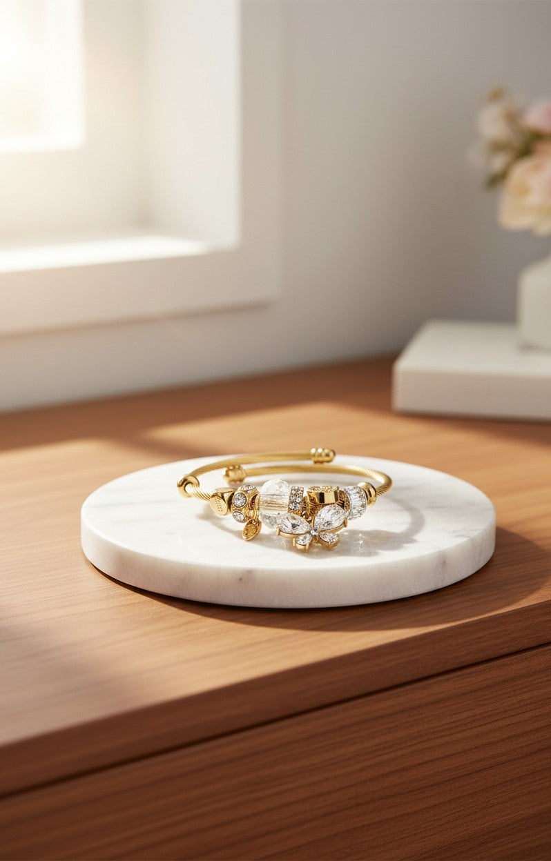Elli Jewellery gold plated bangle featuring a delicate butterfly motif with sparkling pavé-set diamanté crystals.