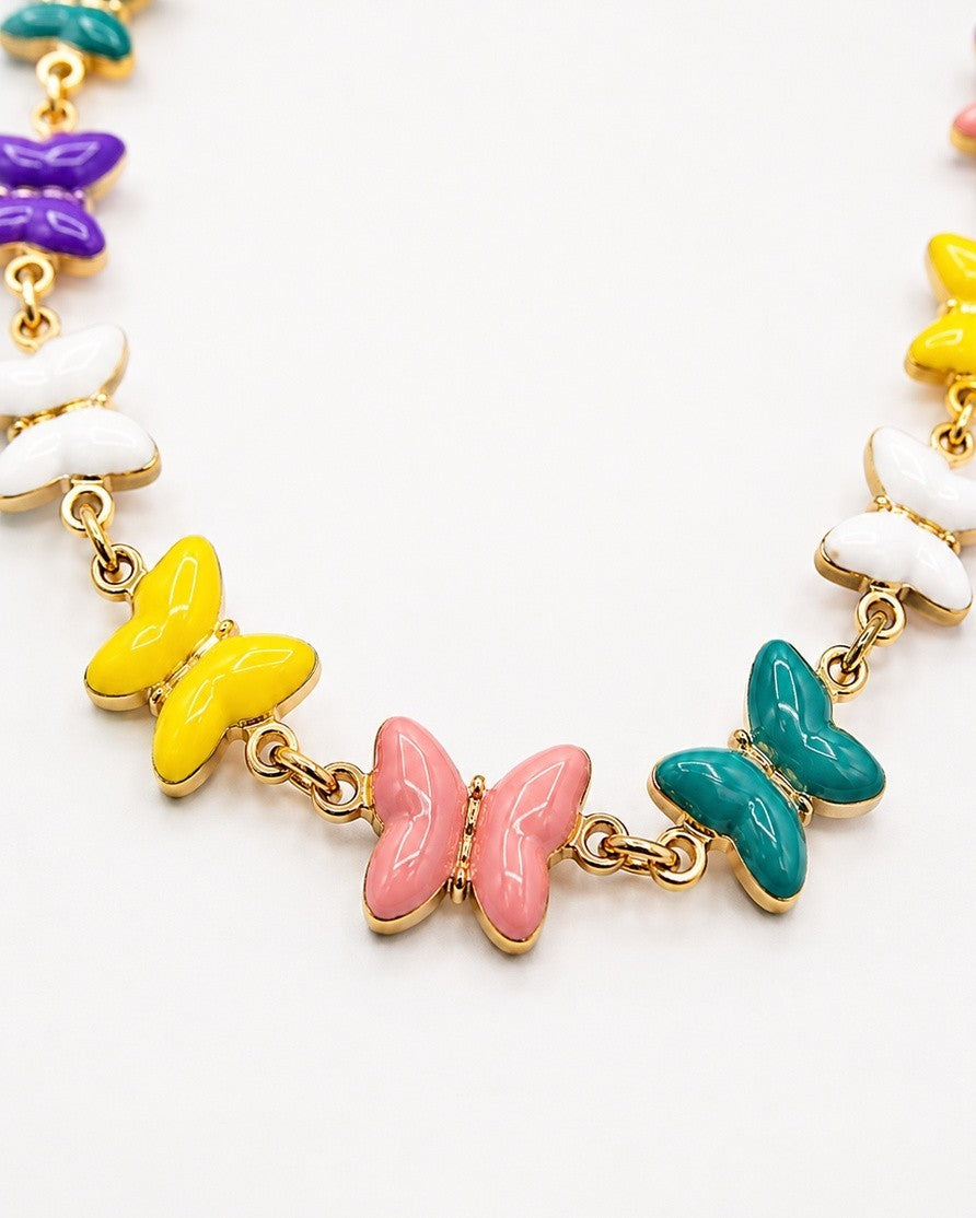 Elli Jewellery gold plated chain necklace featuring vibrant multi-coloured enamel butterfly charms on a white background