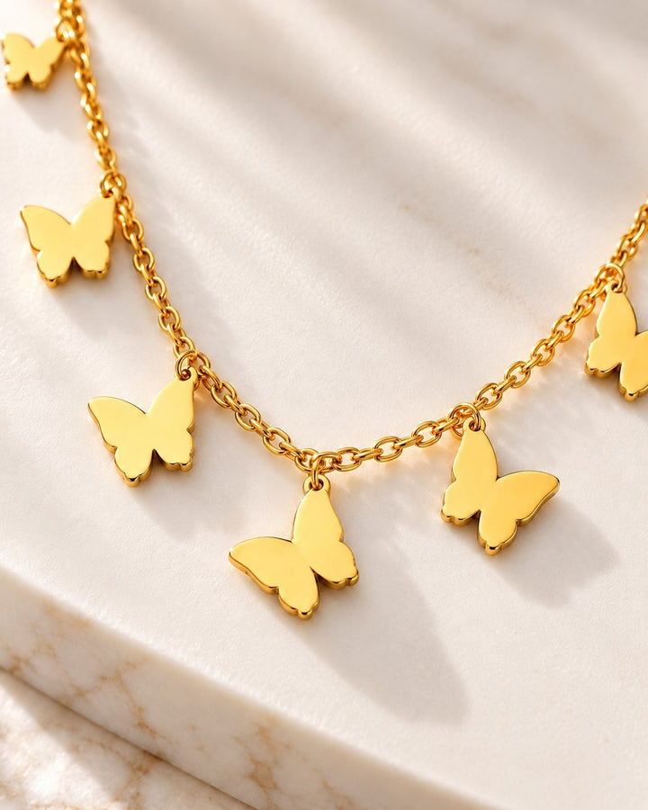 Elli Jewellery gold plated waterproof necklace featuring delicate butterfly charms on a dainty chain