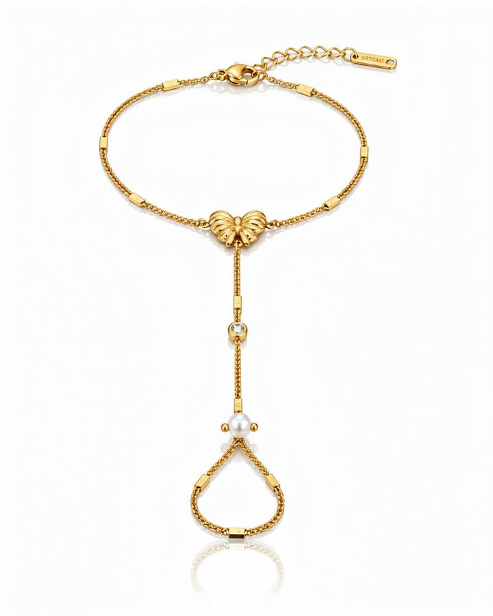 Elli Jewellery gold plated hand chain bracelet featuring a butterfly charm, a small crystal, and a pearl accent.