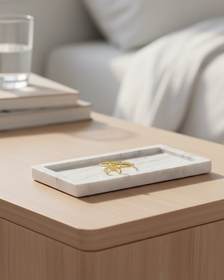 Elli Jewellery gold plated butterfly statement ring with crystal accents resting on a white marble tray