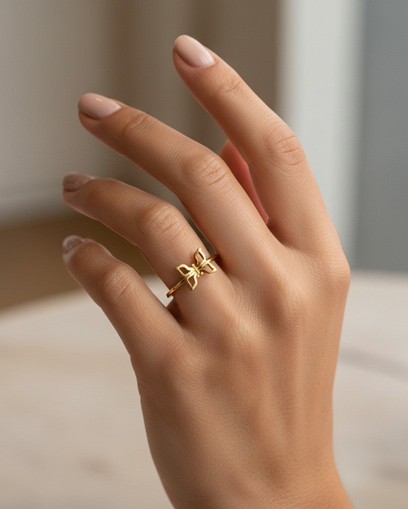 Elli Jewellery gold plated butterfly ring with crystal accents worn on a finger