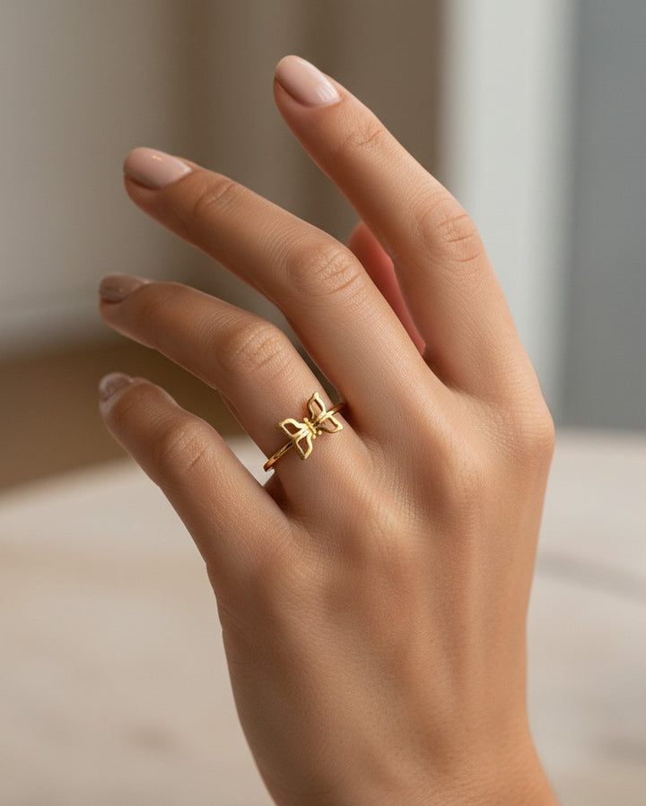 Elli Jewellery gold plated butterfly ring with crystal accents worn on a finger