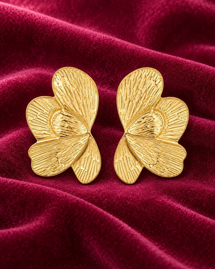 Elli Jewellery sculptural butterfly stud earrings in 18ct gold plated metal with etched linear texture on velvet