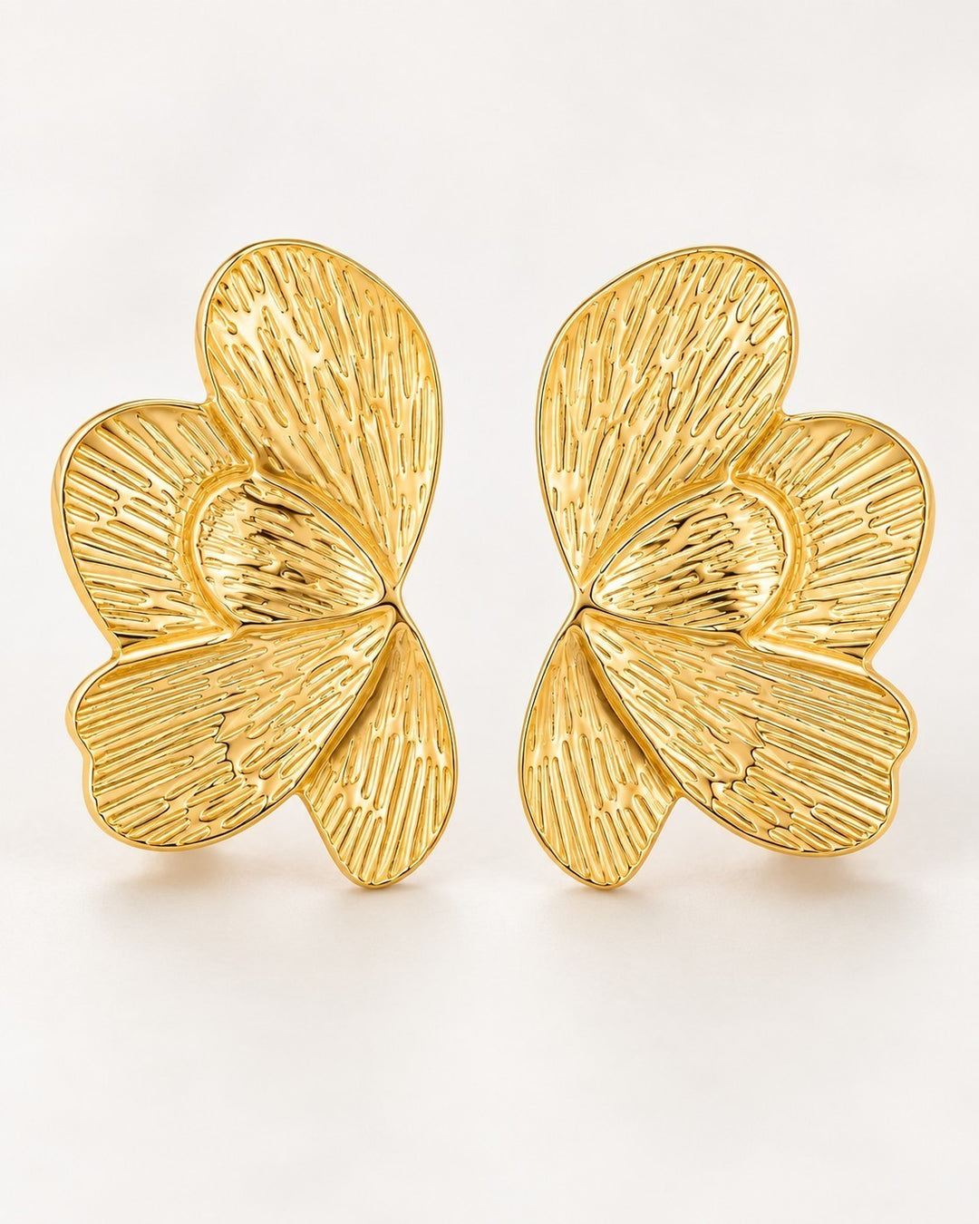 Elli Jewellery sculptural butterfly stud earrings in 18ct gold plated metal with etched linear texture details.