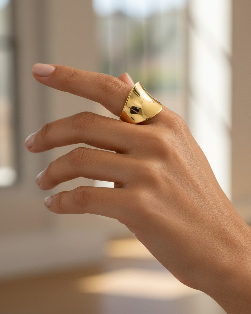 Elli Jewellery gold plated brushed cambered open cuff ring worn on a woman's finger, showcasing a minimalist design.