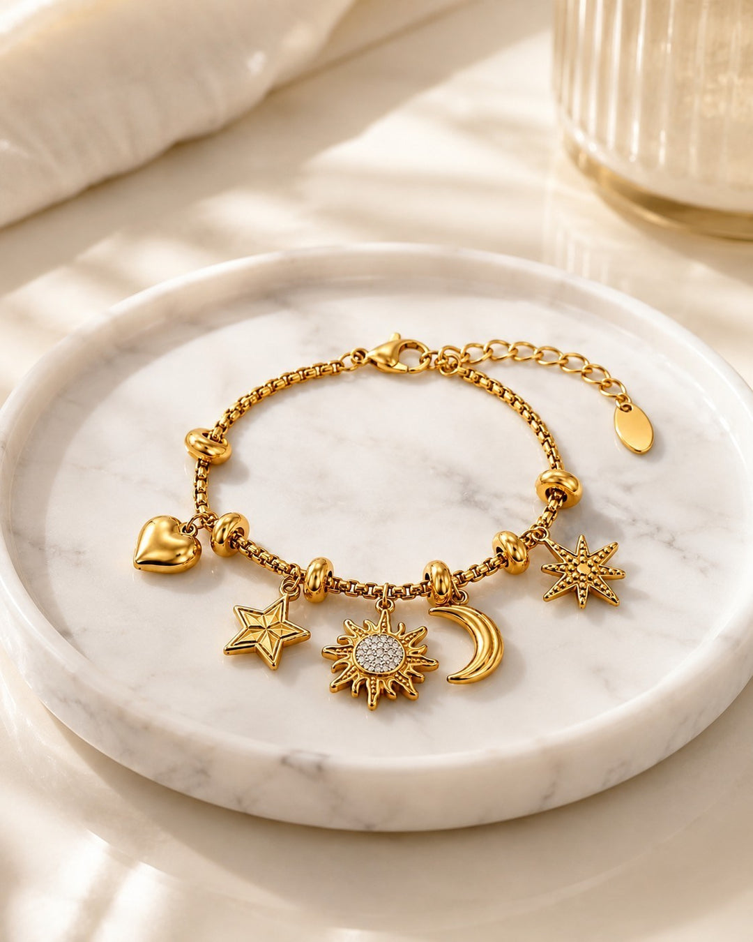 Elli Jewellery gold plated charm bracelet featuring sun, moon, star, and heart pendants on a delicate box chain.