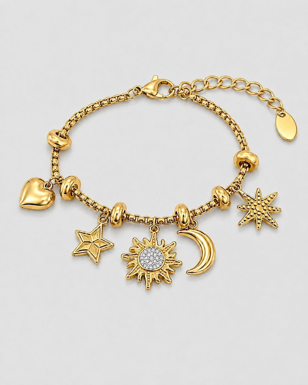 Elli Jewellery gold plated charm bracelet featuring sun, moon, star, and heart motifs on a delicate box chain.