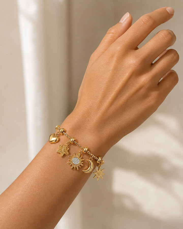 Elli Jewellery gold plated charm bracelet featuring sun, moon, star, and heart pendants on a delicate box chain.