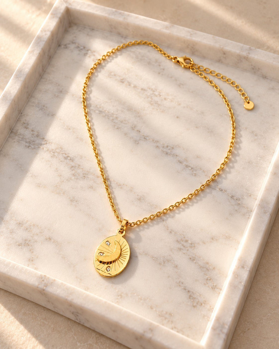 Elli Jewellery gold plated oval pendant necklace featuring a celestial moon and star design on a delicate chain