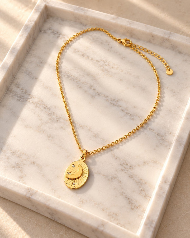 Elli Jewellery gold plated oval pendant necklace featuring a celestial moon and star design on a delicate chain