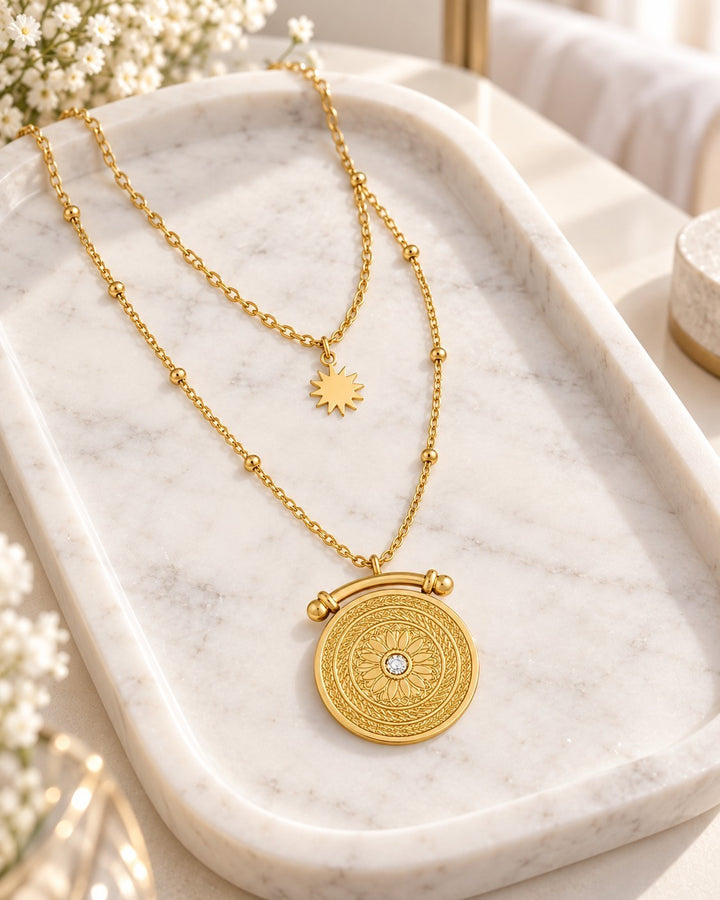 Elli Jewellery gold plated double layered necklace featuring a celestial sun charm and an intricate sundial pendant.