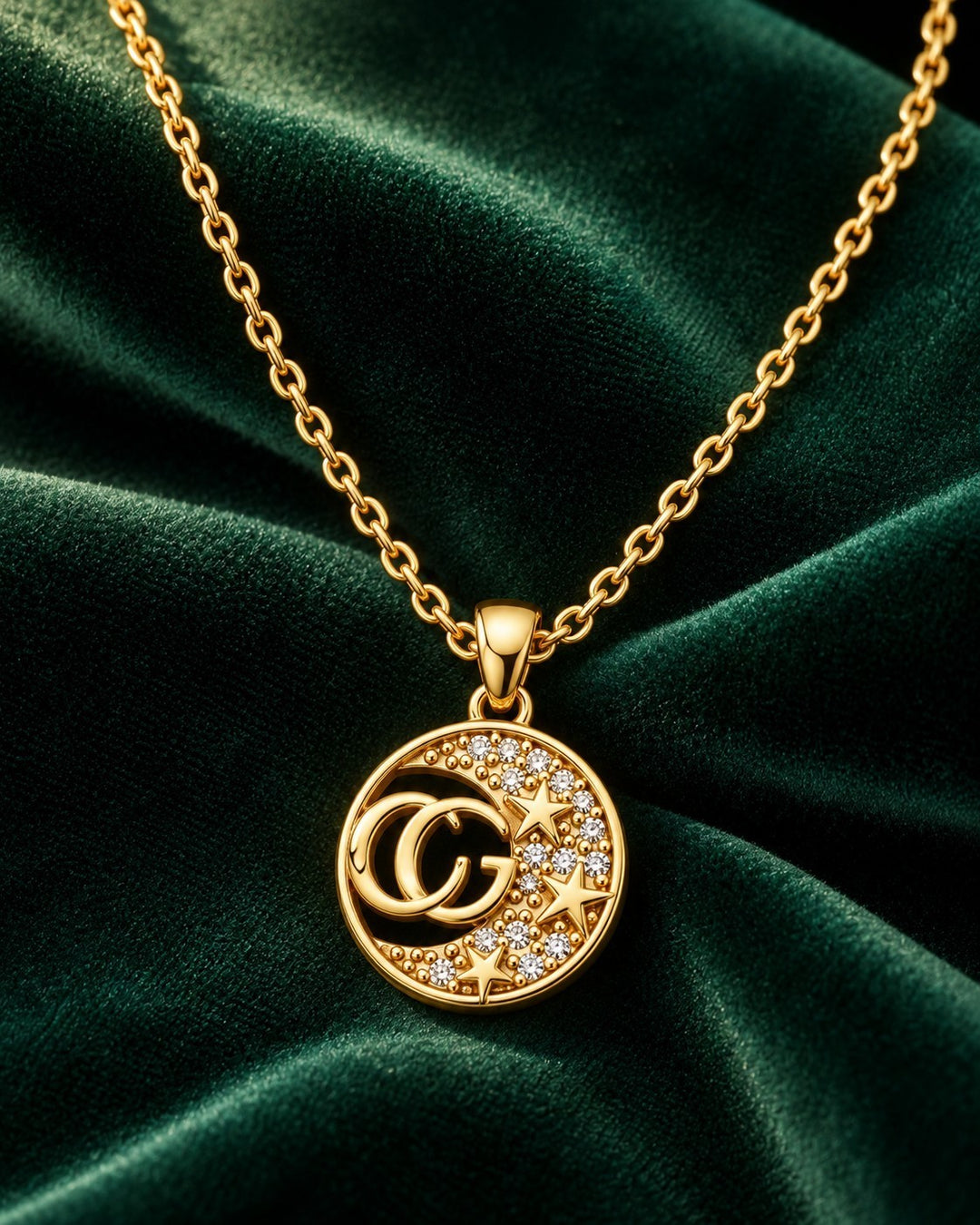 Elli Jewellery gold plated necklace featuring a round pendant with CG initials and star-shaped diamante crystals.