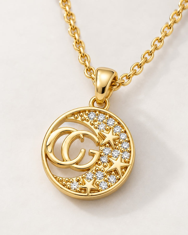Elli Jewellery gold plated necklace with a circular CG initial pendant featuring crystal diamantes and star accents.