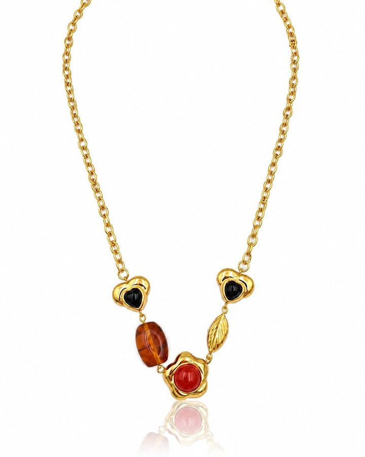 Elli Jewellery gold plated chain necklace featuring heart, amber, and red stone charms on a delicate link chain.