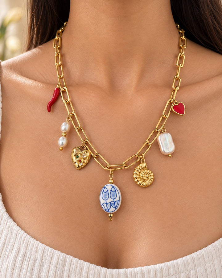 Elli Jewellery gold plated charm necklace featuring a seashell, heart, pearl, and blue floral pendant on a link chain