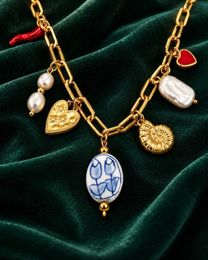 Elli Jewellery gold plated chain necklace featuring assorted charms including pearls, hearts, and a floral pendant.