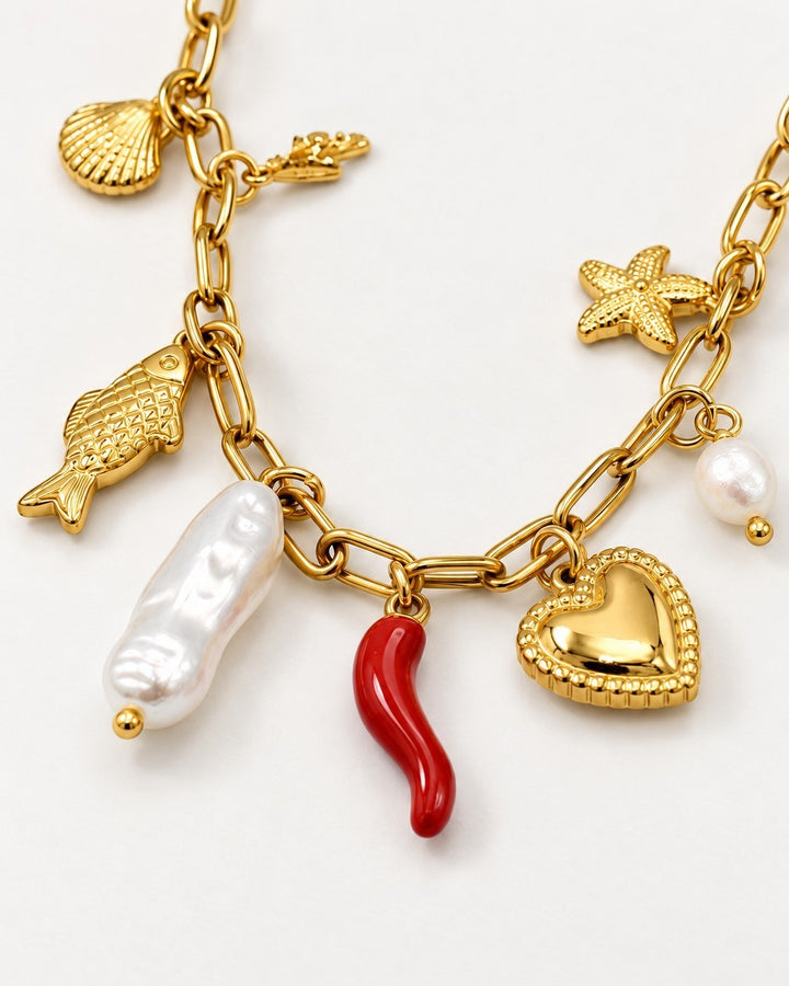 Elli Jewellery gold plated charm necklace featuring a heart, pearl, red chili, fish, and starfish on a chain