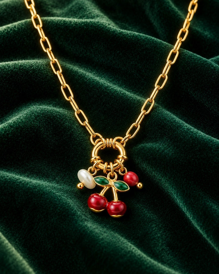 Elli Jewellery gold plated chain necklace featuring a playful cherry charm with red enamel and a small white pearl.