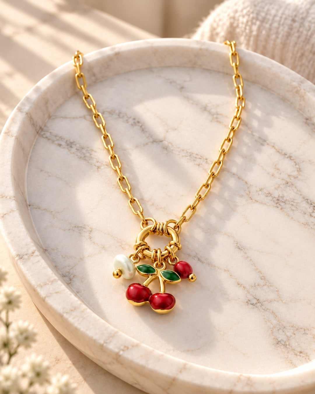 Elli Jewellery gold plated chain necklace featuring a playful cherry charm with red enamel and a small white pearl.