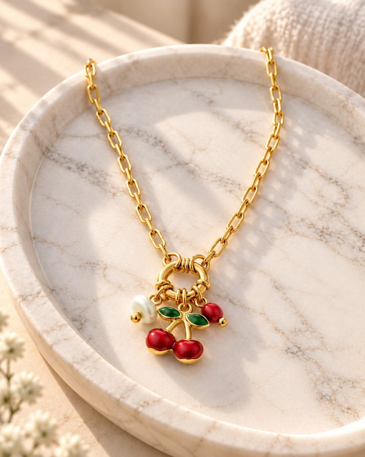 Elli Jewellery gold plated chain necklace featuring a playful cherry charm with red enamel and a small white pearl.