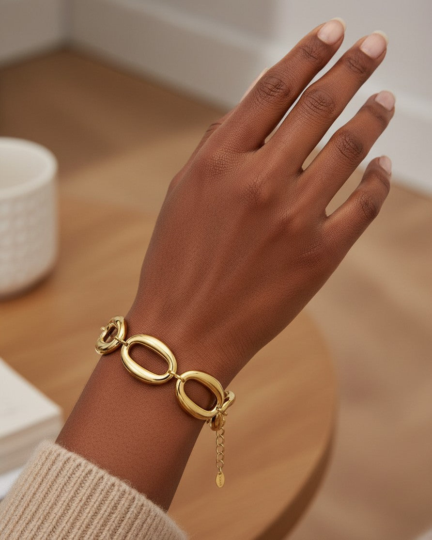 Elli Jewellery gold plated chunky chain link bracelet worn on a model's wrist, featuring large interlocking links.