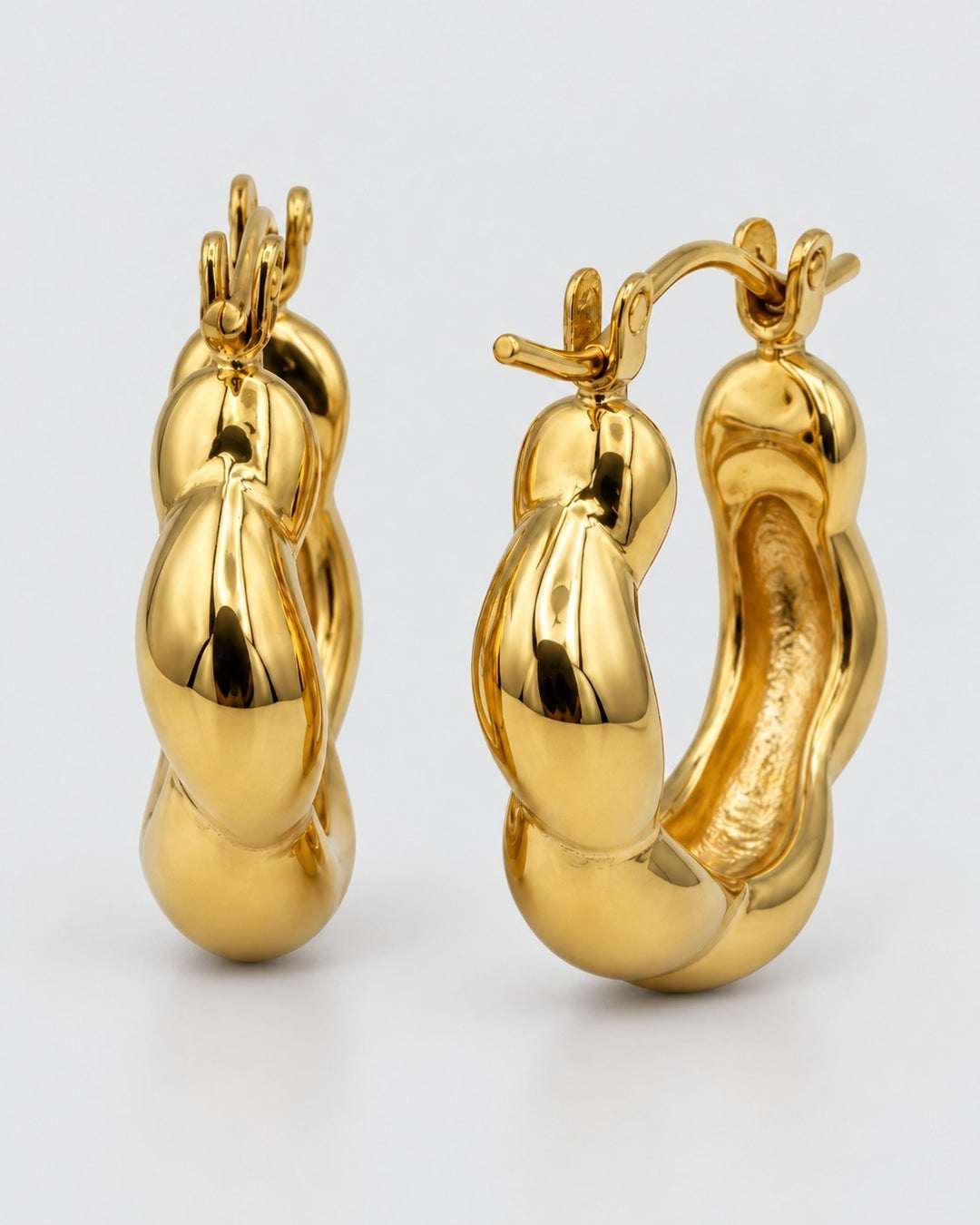 Elli Jewellery gold plated chunky geometric hoop earrings with a sculptural, tarnish-free design on a white background