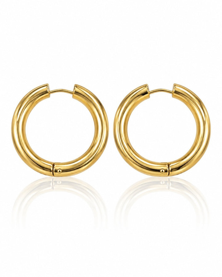 Elli Jewellery gold plated chunky huggie hoop earrings with a polished finish on a white background.