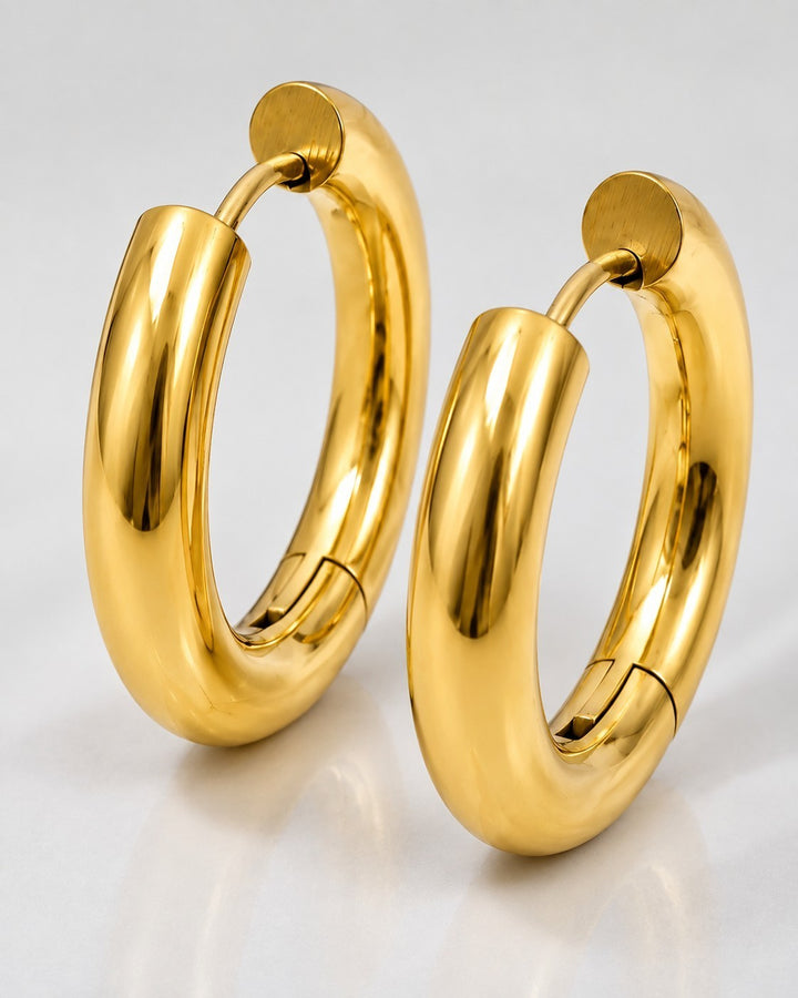 Elli Jewellery gold plated chunky huggie hoop earrings with a polished finish and secure hinged clasp