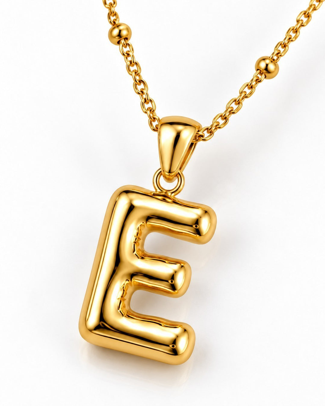 Elli Jewellery gold plated chunky initial E pendant necklace on a delicate beaded chain against a white background