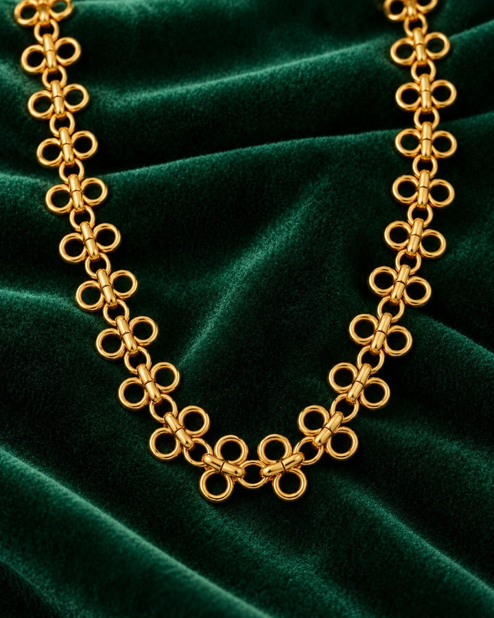 Elli Jewellery gold plated waterproof necklace featuring a modern interlocking circle link chain on green velvet.